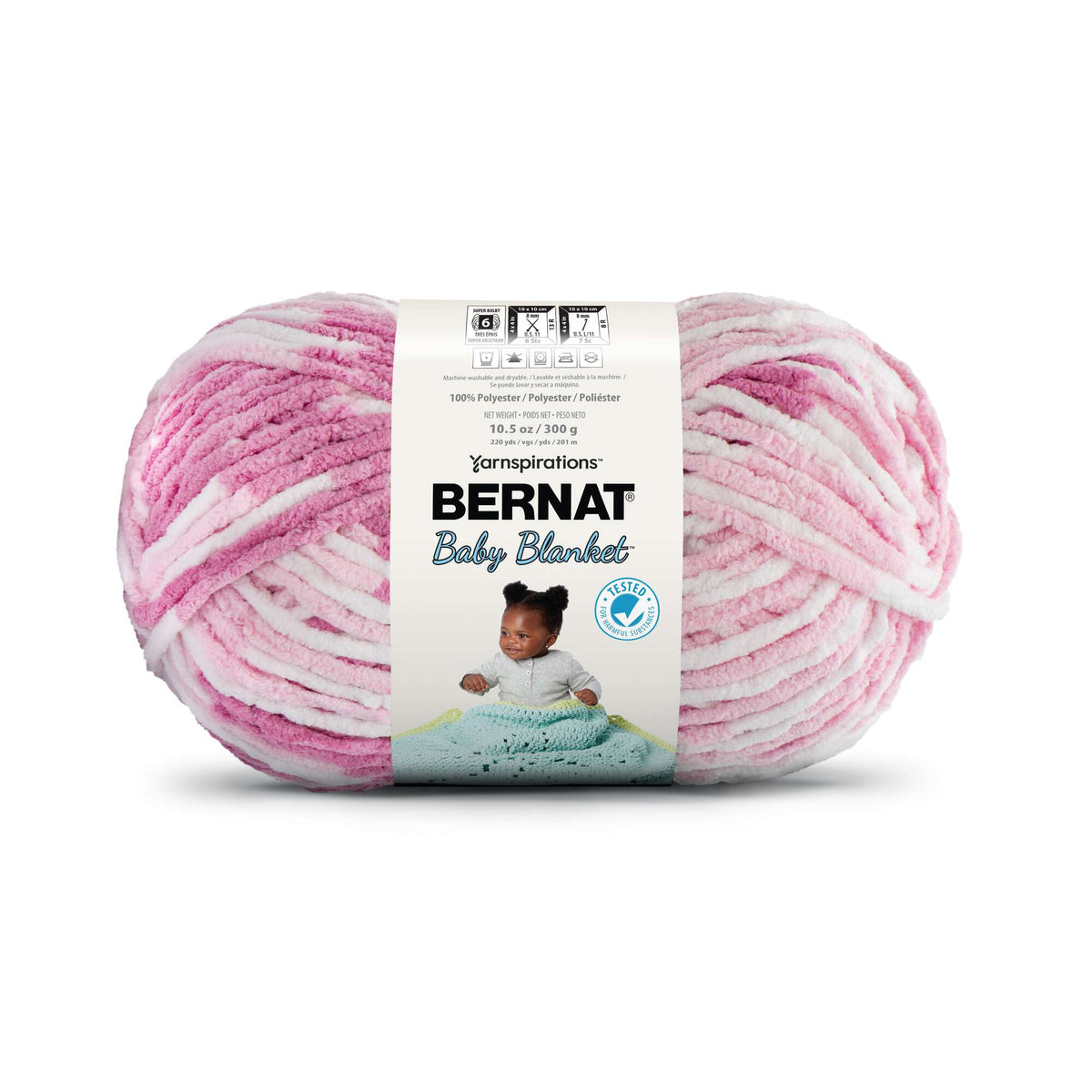 Pink and white yarn ball with Bernat Baby Blanket label on a white background
